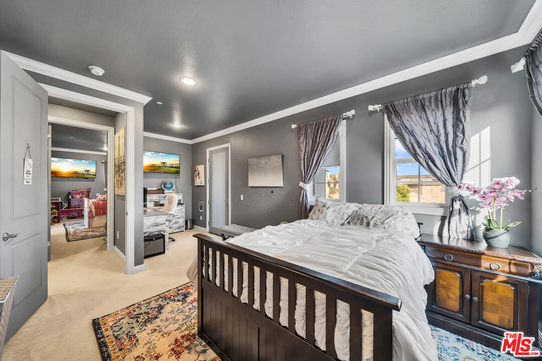 7313 Rocky Top Circle Moorpark, CA 93021 - Photo 18 of 33 a bedroom with a bed and dresser with mirror