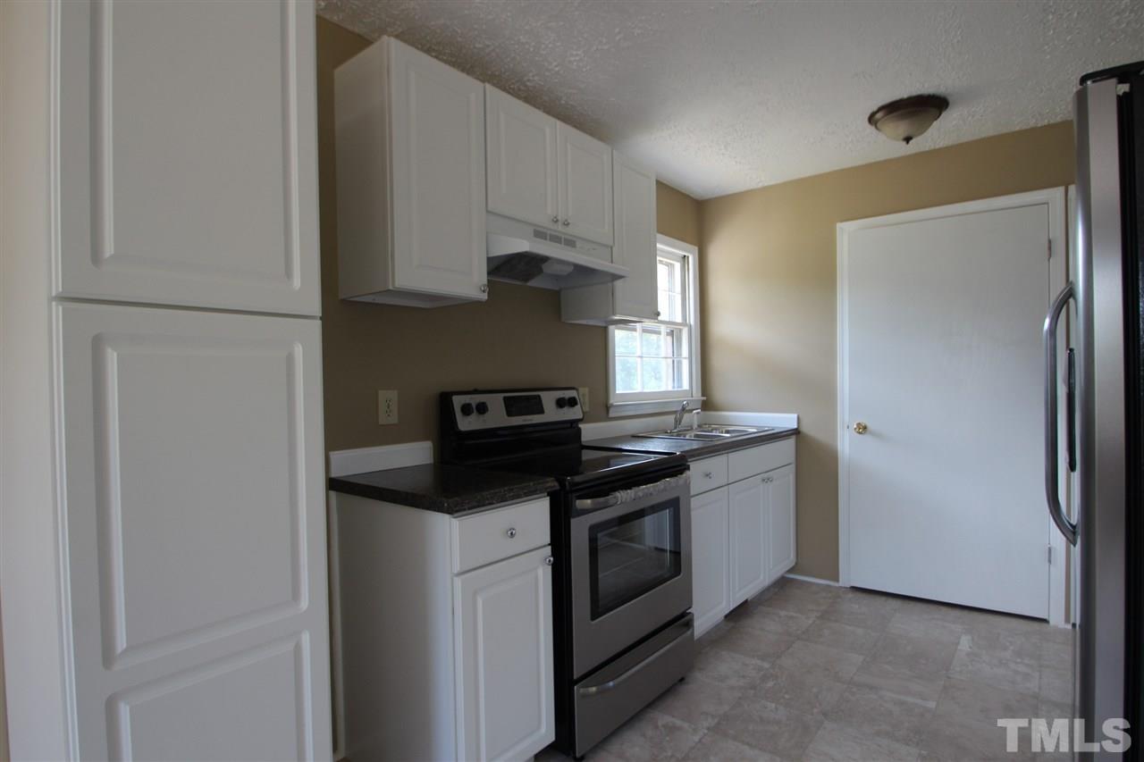 510 Fontaine Road Roxboro, NC 27574 - Photo 2 of 10 a kitchen with stainless steel appliances granite countertop a refrigerator and a stove