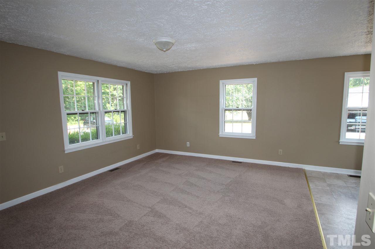 510 Fontaine Road Roxboro, NC 27574 - Photo 5 of 10 an empty room with windows