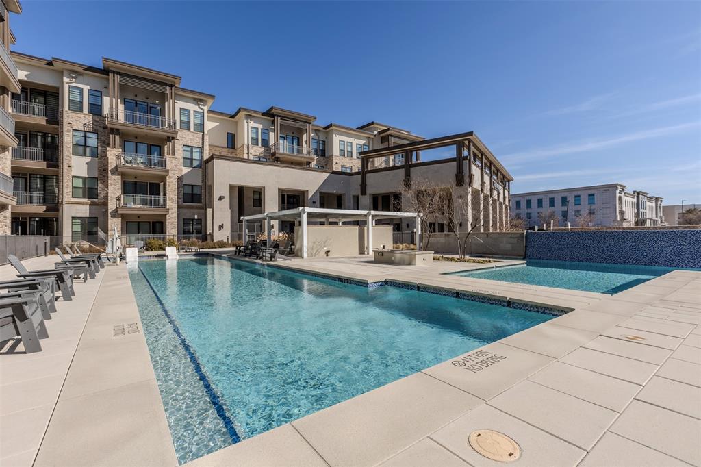2700 Old Denton Road, Unit 1044 Carrollton, TX 75007 - Photo 30 of 33 Outdoor aquatic area featuring a large swimming pool, a secondary shallow pool, and a tiled water feature