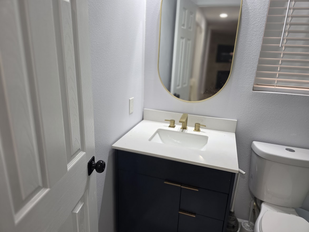 4803 Peach Grove Road Austin, TX 78744 - Photo 10 of 22 a bathroom with a sink toilet a mirror and vanity