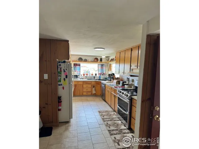 a kitchen with stainless steel appliances a refrigerator and a sink