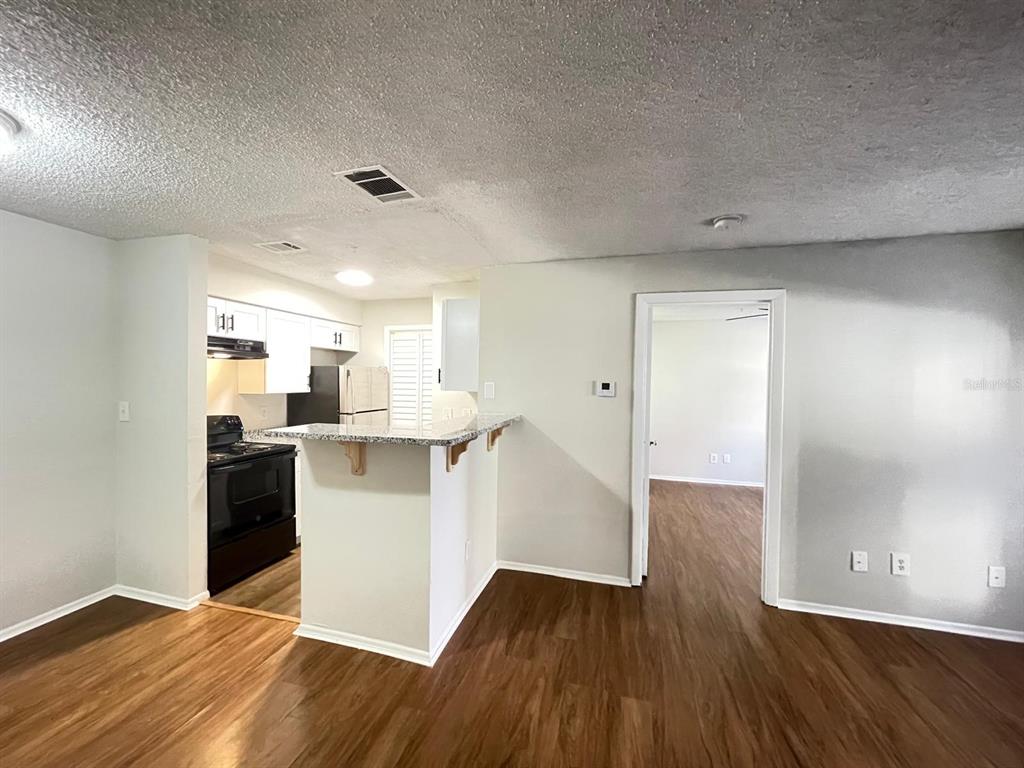 238 Afton Square, Unit 106 Altamonte Springs, FL 32714 - Photo 6 of 33 a view of a kitchen cabinets and wooden floor