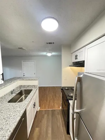 a kitchen that has a sink and a stove in it