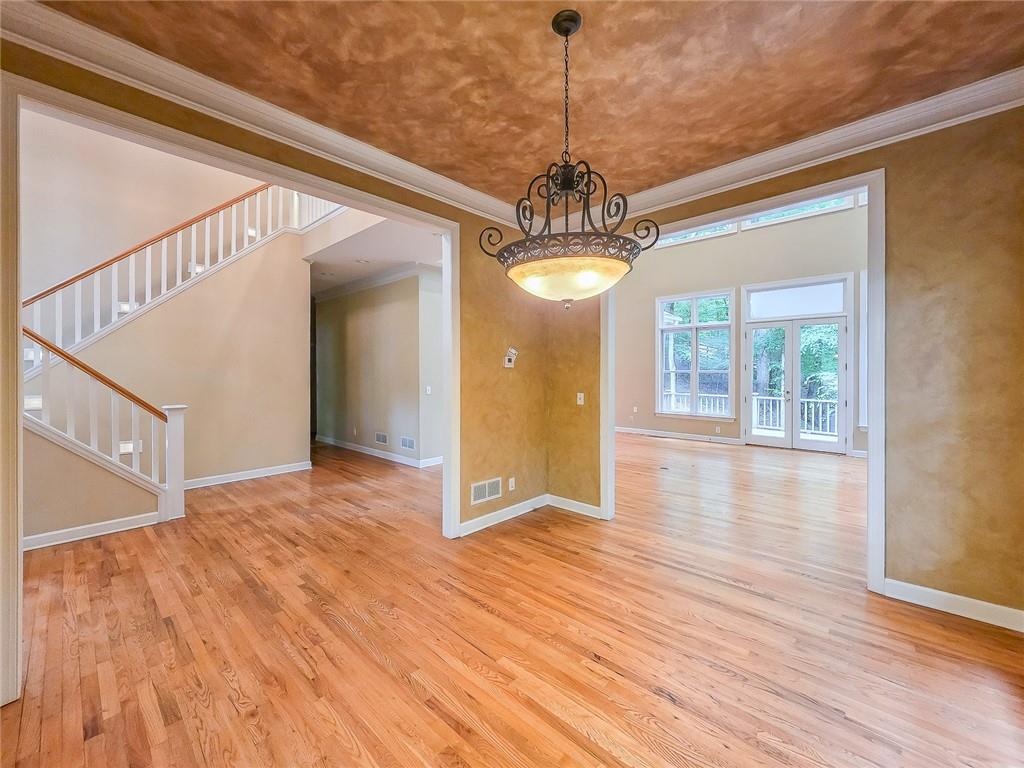 3712 Frederica Road Northwest Berkeley Lake, GA 30096 - Photo 23 of 49 a view of a hallway with wooden floor and chandelier