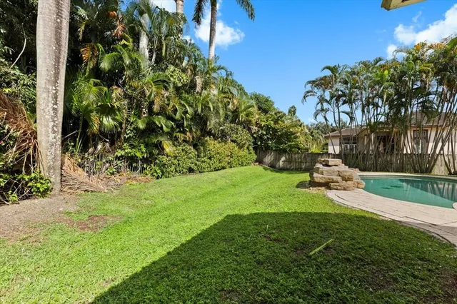 an aerial view of a house with a yard and garden