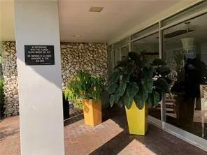 a vase of flowers sitting next to a wall