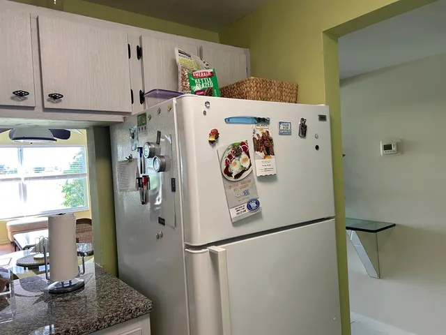 a white refrigerator freezer sitting inside of a kitchen