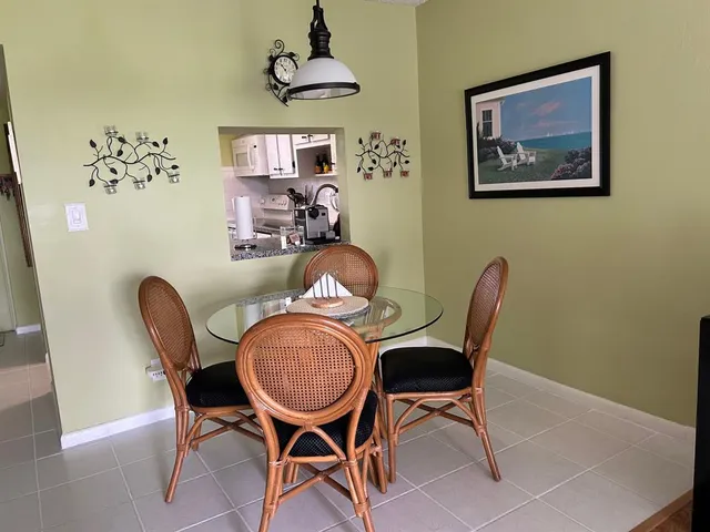 a dining room with furniture and window
