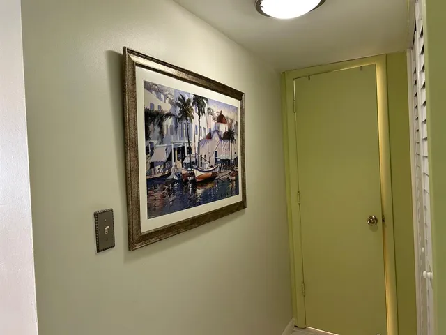 a view of a hallway with a painting on the wall