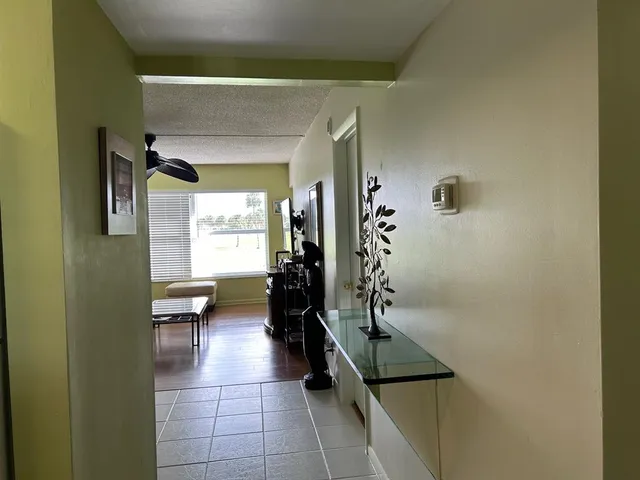 a hallway with a couch and chairs