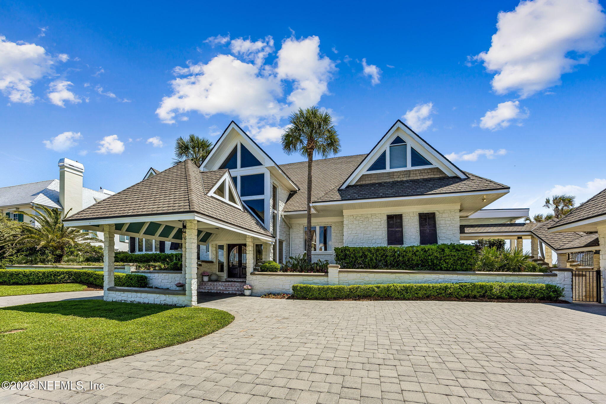4 Ocean Ridge Court Ponte Vedra Beach, FL 32082 - Photo 129 of 132 a view of a white house with a yard and potted plants