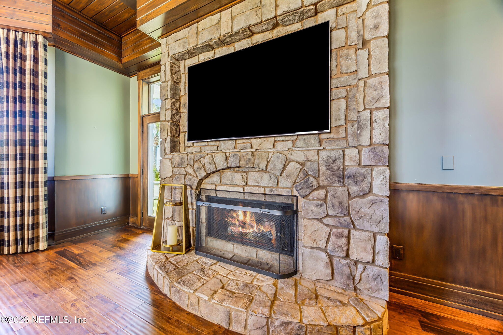 4 Ocean Ridge Court Ponte Vedra Beach, FL 32082 - Photo 40 of 132 a living room with a fireplace and a flat screen tv