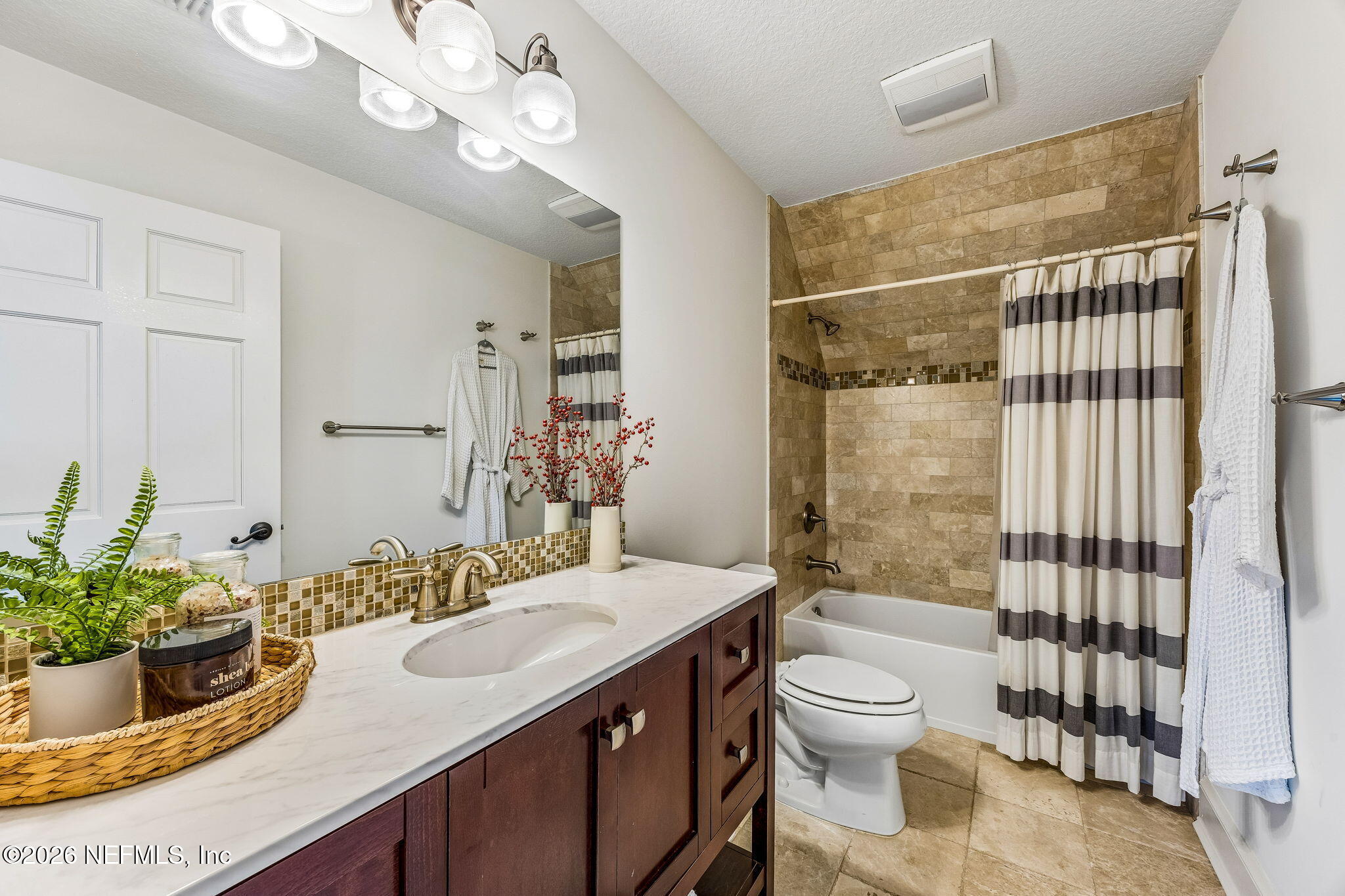 4 Ocean Ridge Court Ponte Vedra Beach, FL 32082 - Photo 89 of 132 a bathroom with a granite countertop sink a toilet a mirror and shower