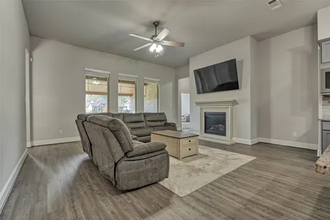 a living room with furniture a fireplace and a flat screen tv