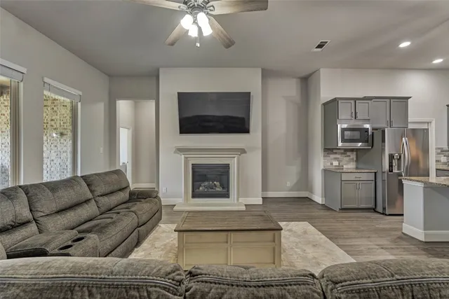 a living room with furniture a fireplace and a flat screen tv