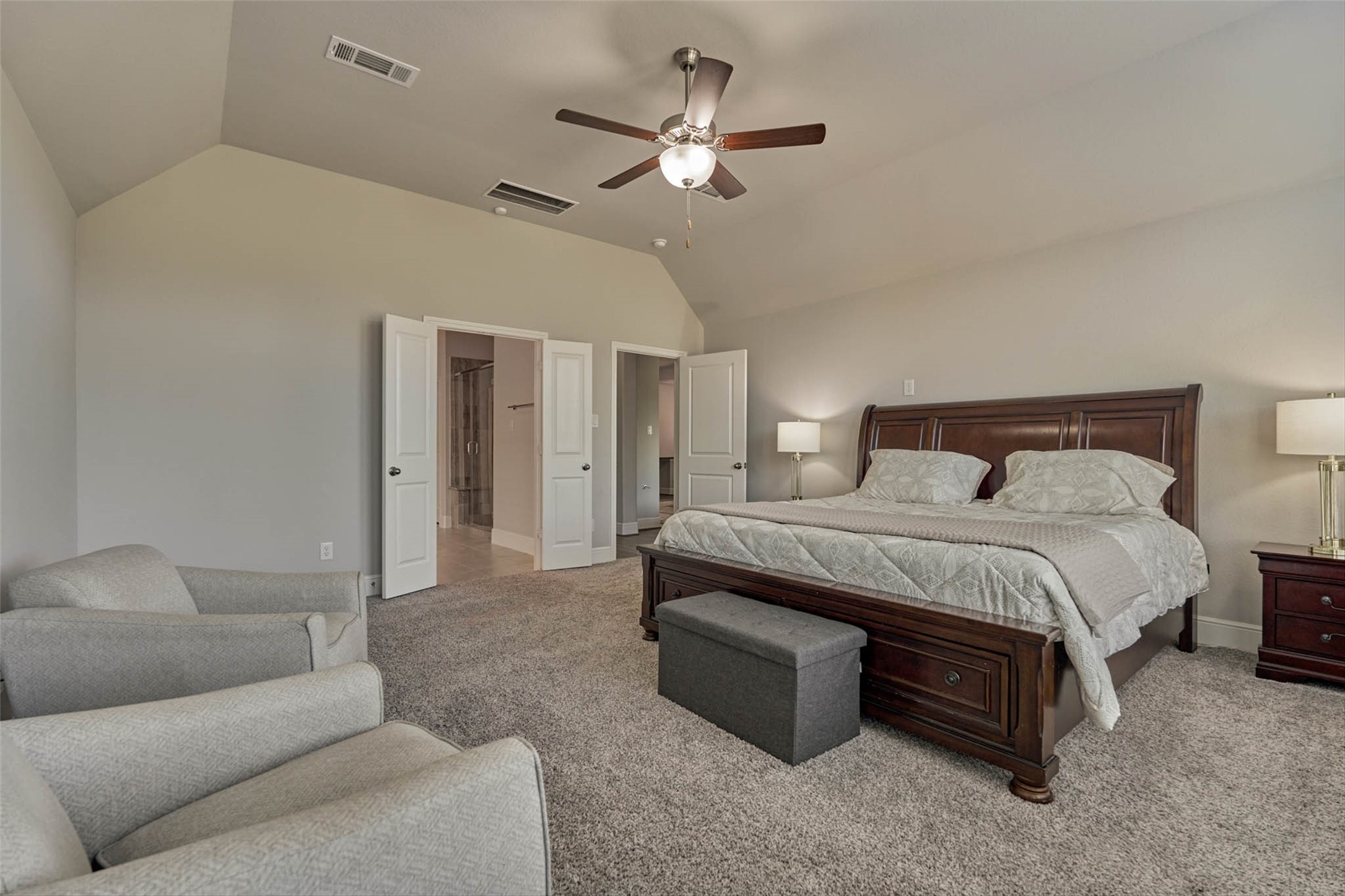 10660 Red Tail Place Conroe, TX 77385 - Photo 21 of 50 a bedroom with a large bed couch and ceiling fan