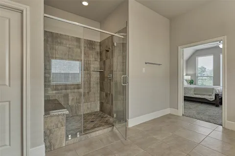 a bathroom with a glass shower door