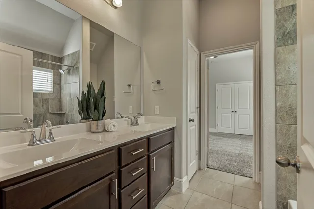 a bathroom with a granite countertop sink a toilet and shower