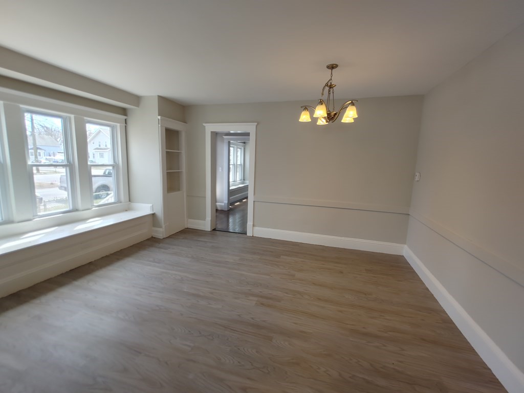 154 Phoenix Terrace Springfield, MA 01104 - Photo 8 of 25 wooden floor in an empty room with a window
