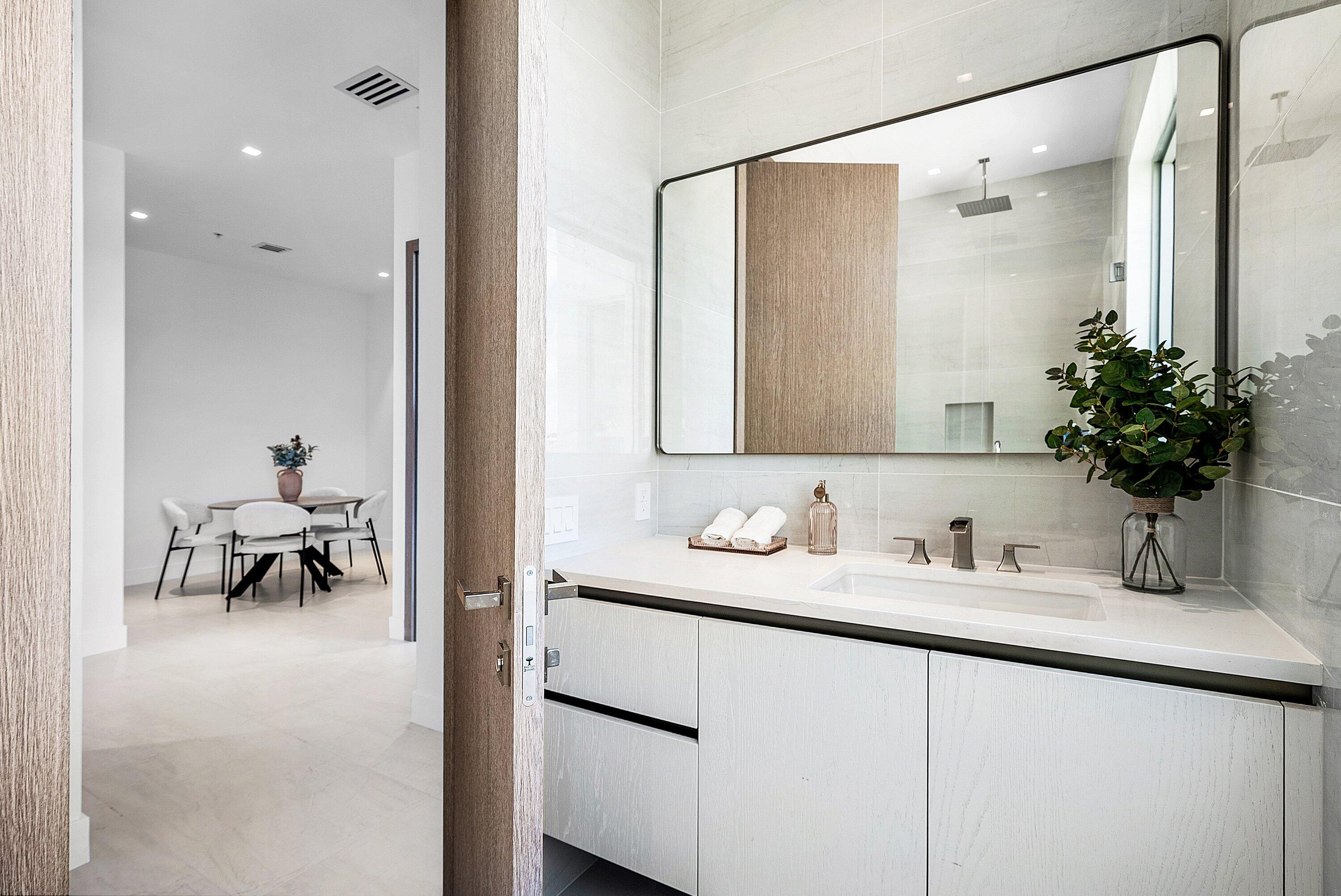 246 Northeast 6th Avenue, Unit 3B Delray Beach, FL 33483 - Photo 16 of 23 a bathroom with a sink and a mirror
