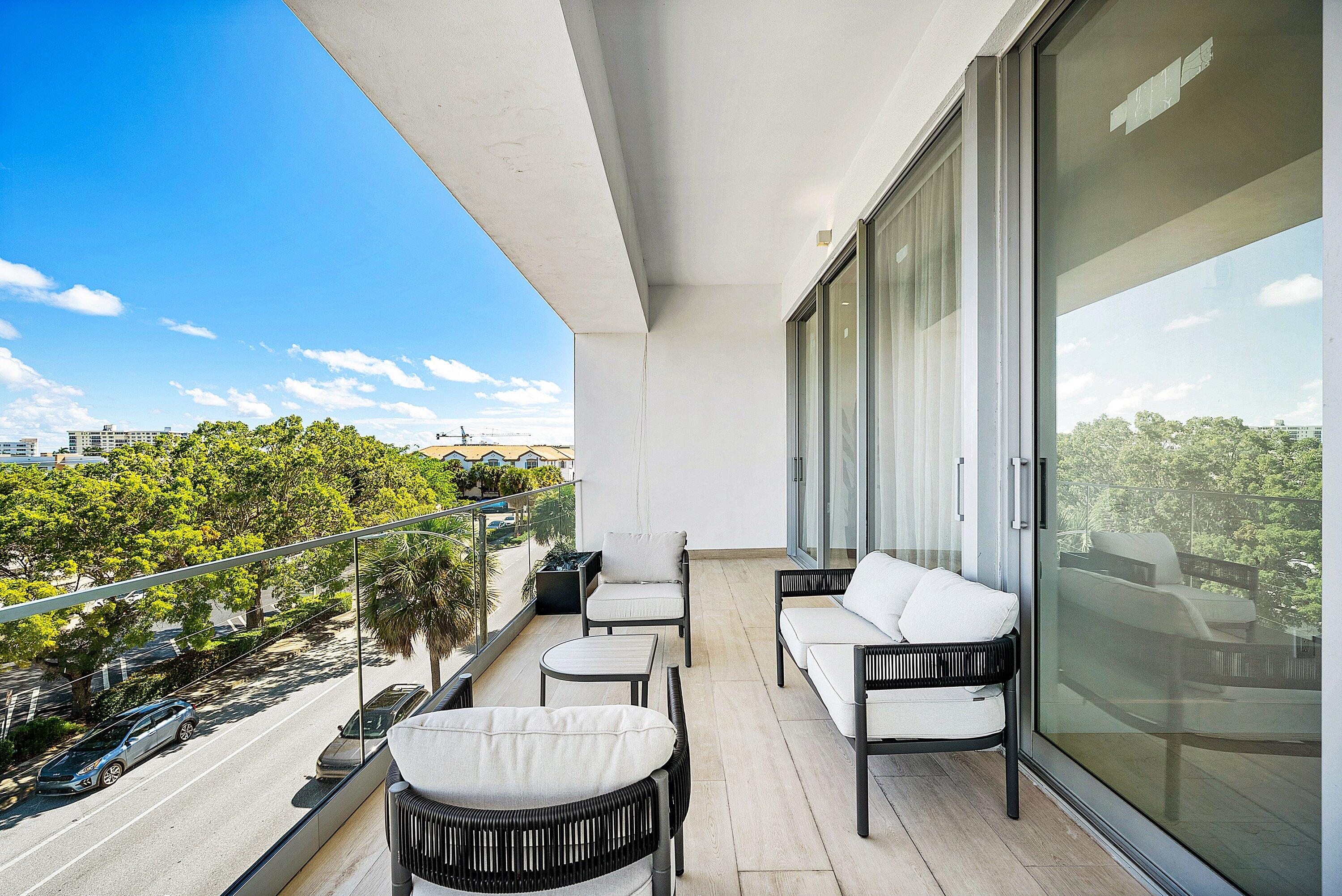 246 Northeast 6th Avenue, Unit 3B Delray Beach, FL 33483 - Photo 19 of 23 a balcony with chairs and a table