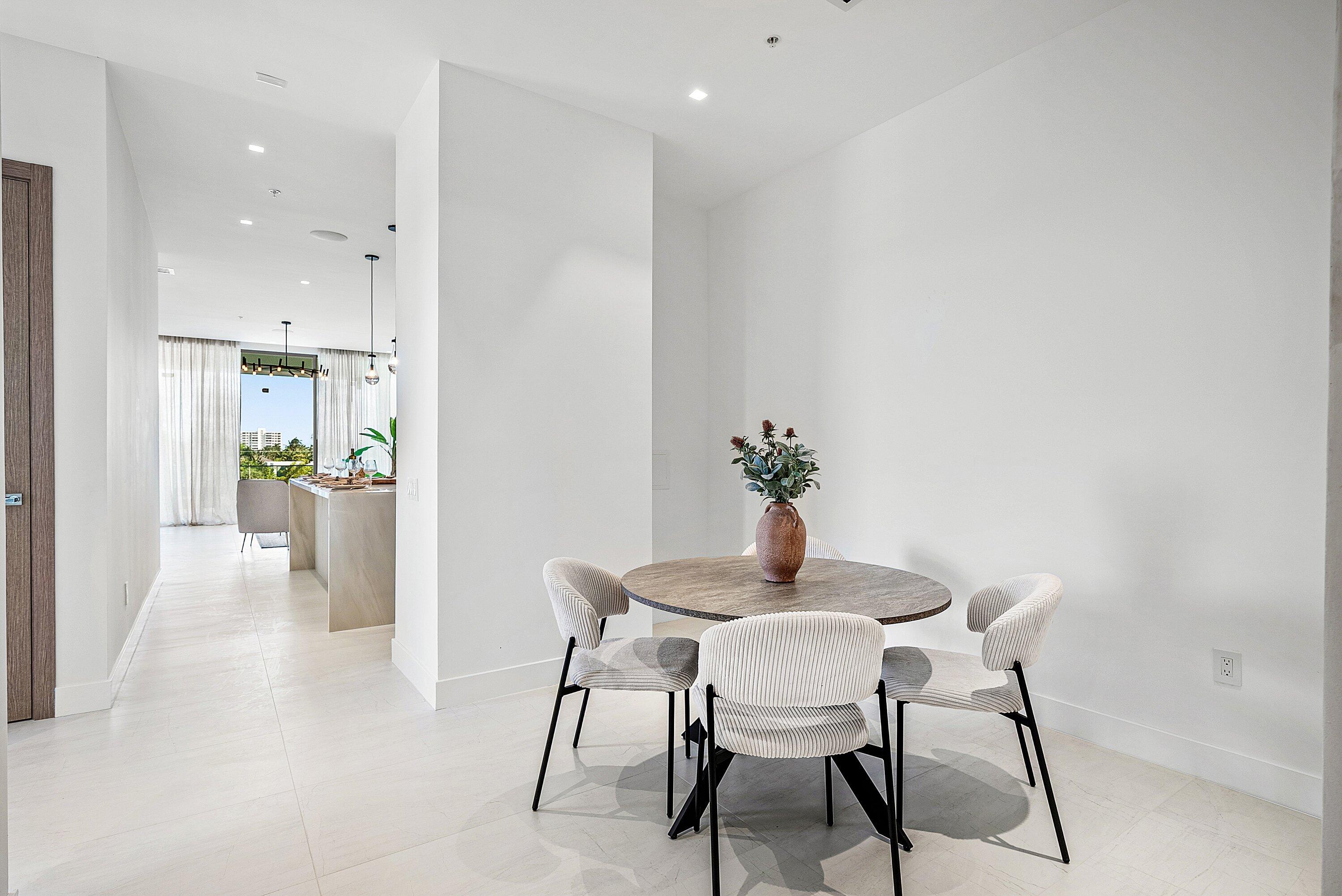 246 Northeast 6th Avenue, Unit 3B Delray Beach, FL 33483 - Photo 3 of 23 a view of a dining room with furniture and wooden floor