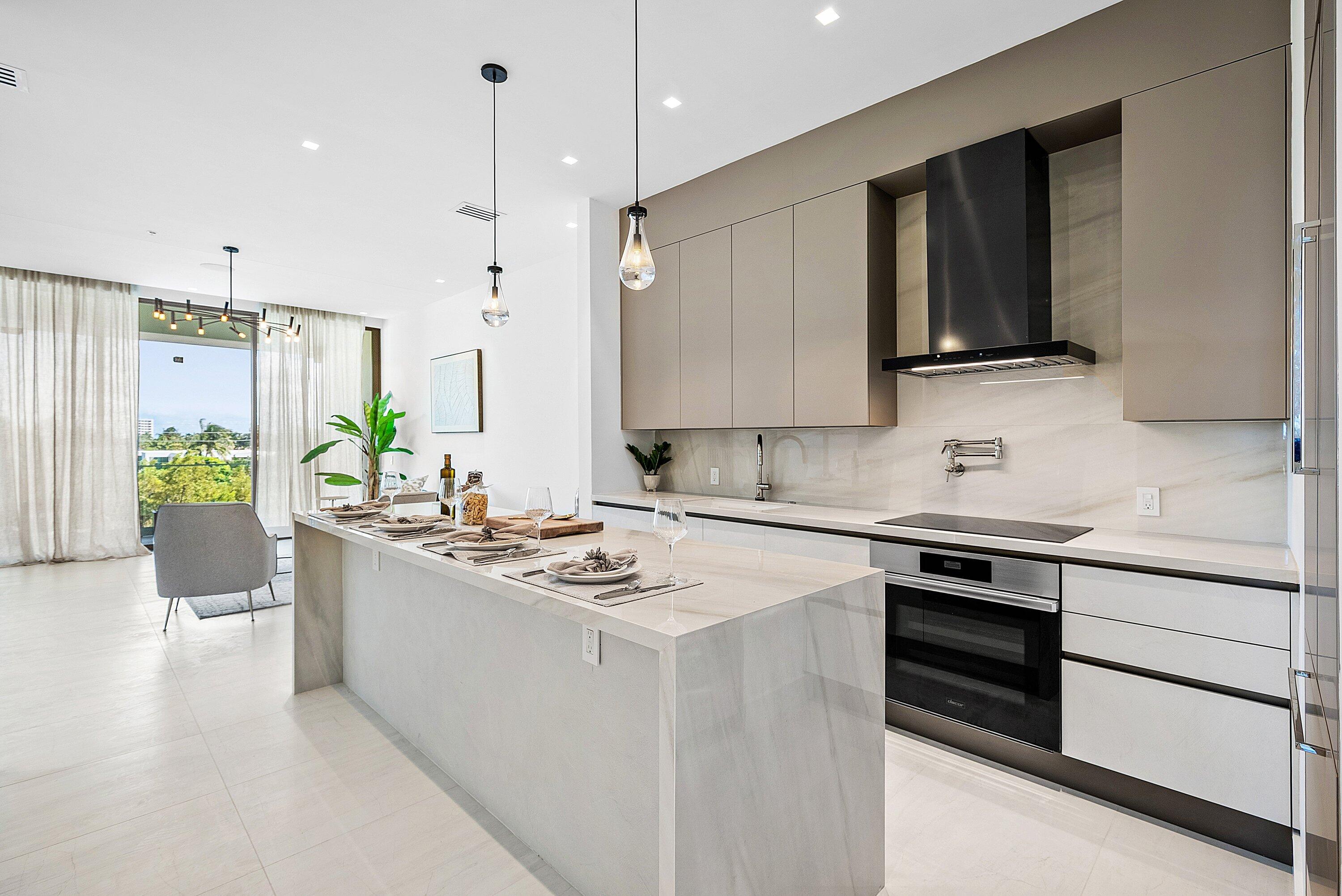 246 Northeast 6th Avenue, Unit 3B Delray Beach, FL 33483 - Photo 4 of 23 a kitchen with stainless steel appliances granite countertop a sink stove and refrigerator