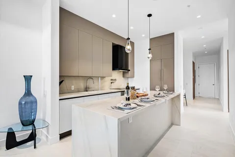 a bathroom with a double vanity sink a mirror and shower