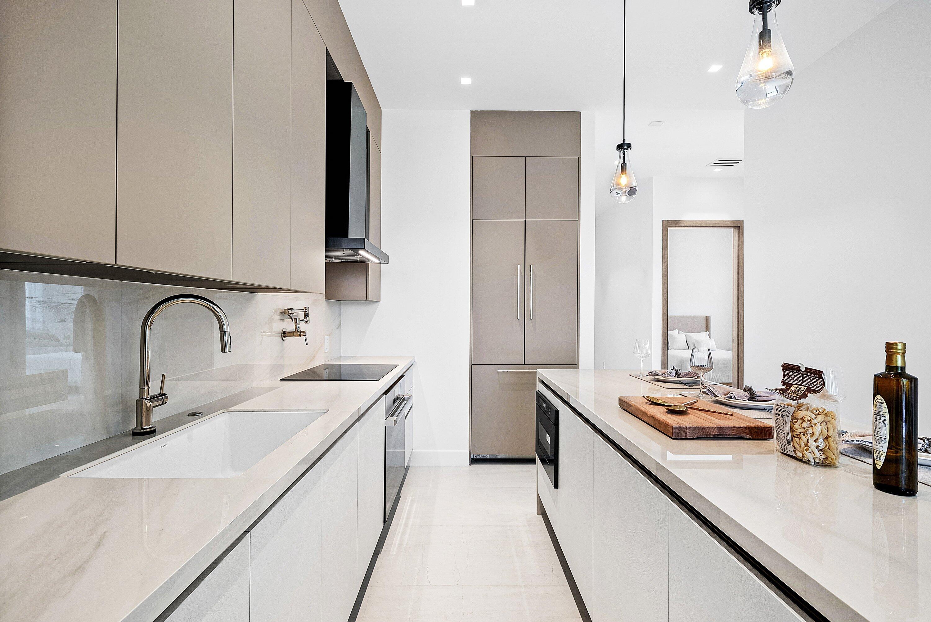246 Northeast 6th Avenue, Unit 3B Delray Beach, FL 33483 - Photo 6 of 23 a kitchen with a sink a stove and cabinets