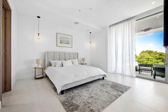 a spacious bedroom with a bed and a window