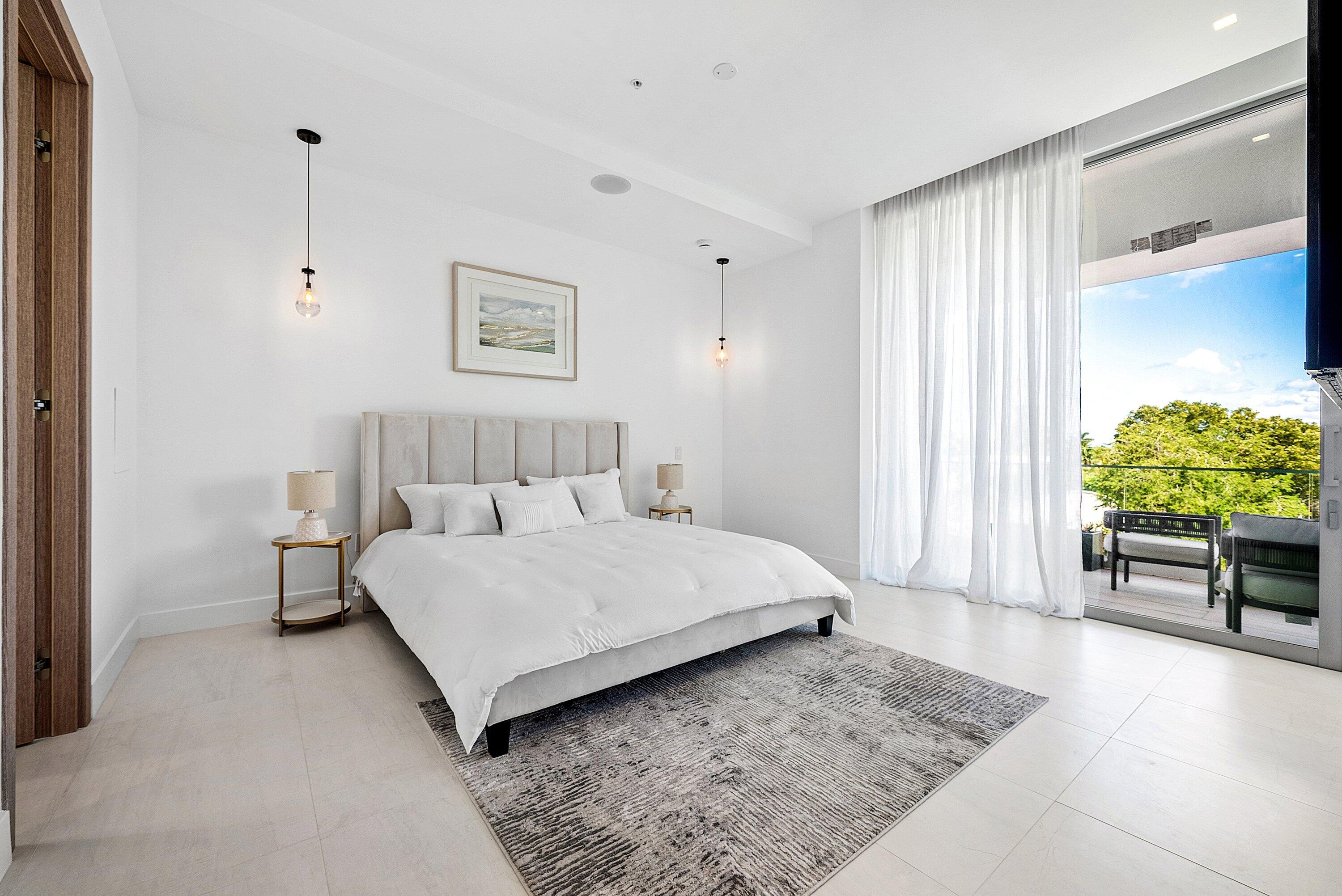 246 Northeast 6th Avenue, Unit 3B Delray Beach, FL 33483 - Photo 10 of 23 a spacious bedroom with a bed and a window