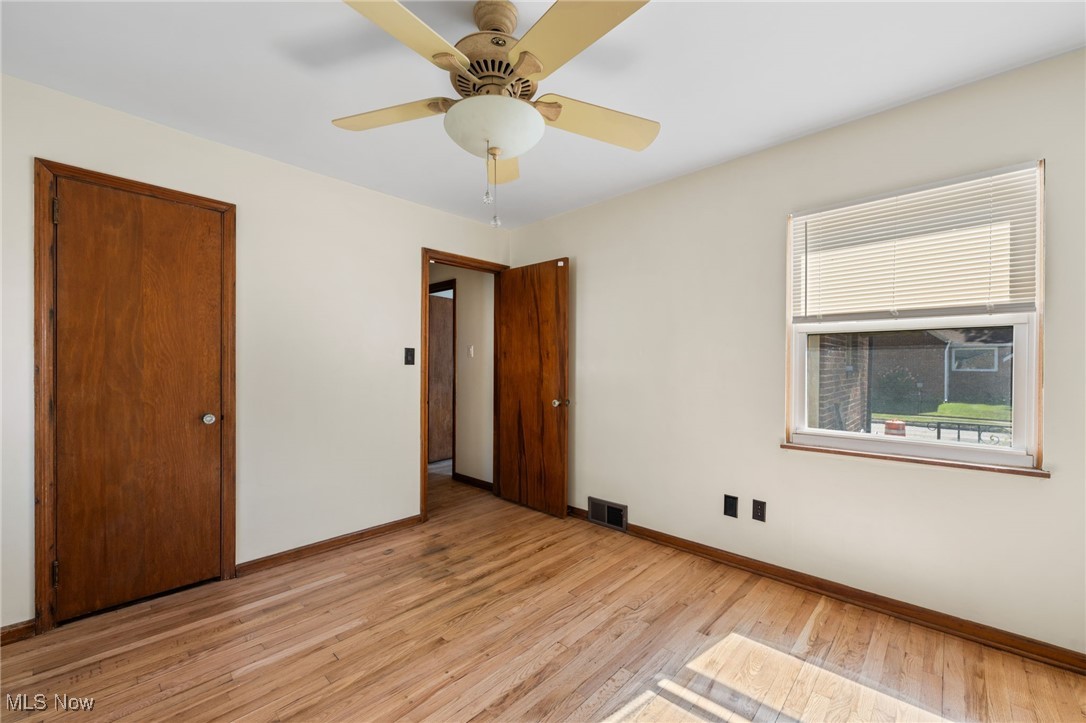18122 Nottingham Road Cleveland, OH 44119 - Photo 15 of 29 Unfurnished bedroom with light wood-type flooring, a ceiling fan, and a closet