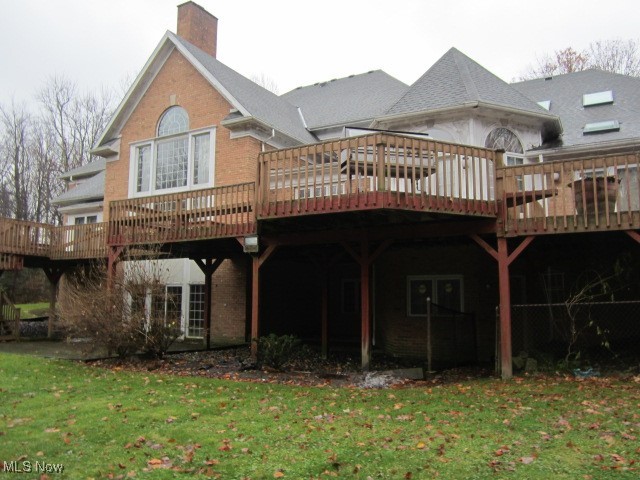 6999 Gates Road Gates Mills, OH 44040 - Photo 2 of 20 Rear view of property with a deck, a chimney, a lawn, and brick siding