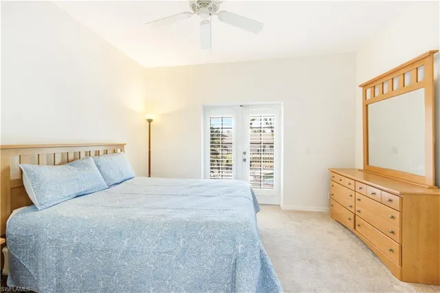 a spacious bedroom with a bed and a chandelier