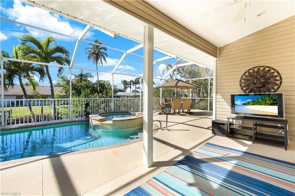 a living room view with a floor to ceiling window next to a yard