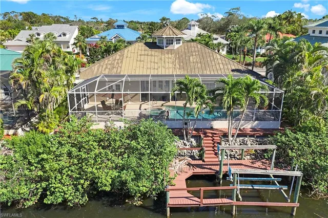 an aerial view of residential houses with outdoor space and lake view