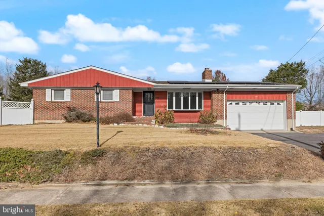 a front view of a house with a yard and balcony