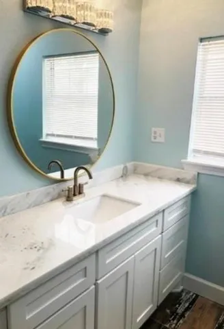 a bathroom with a sink and a mirror