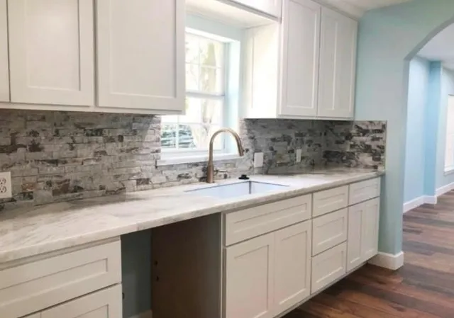 a kitchen with sink and cabinets