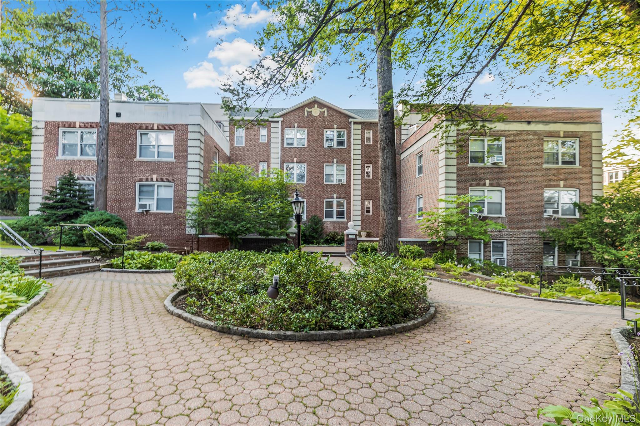 766 Palmer Road, Unit 2D Bronxville, NY 10708 - Photo 18 of 21 a view of a large brick building next to a yard