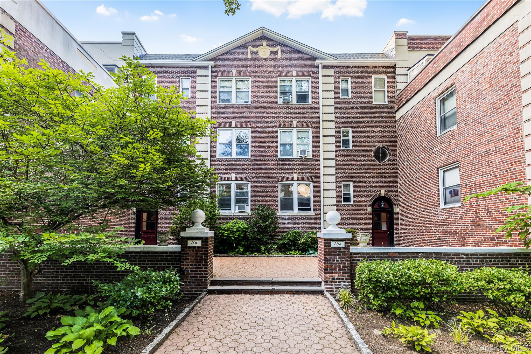 766 Palmer Road, Unit 2D Bronxville, NY 10708 - Photo 19 of 21 a front view of a house with a yard