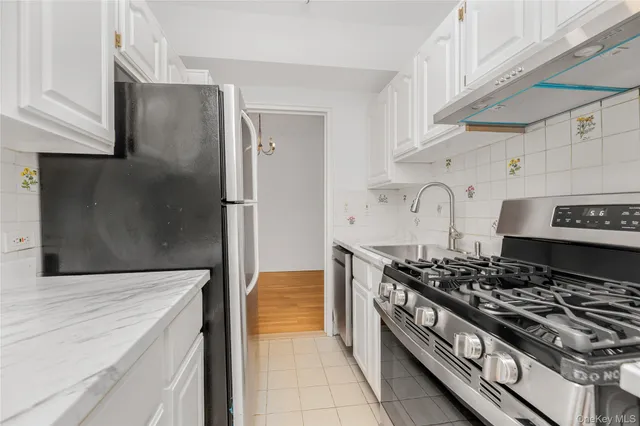 a kitchen with stainless steel appliances granite countertop a stove and a refrigerator