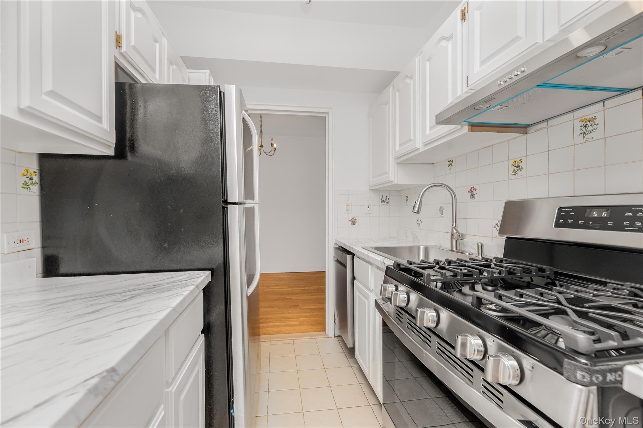 766 Palmer Road, Unit 2D Bronxville, NY 10708 - Photo 4 of 21 a kitchen with stainless steel appliances granite countertop a stove and a refrigerator
