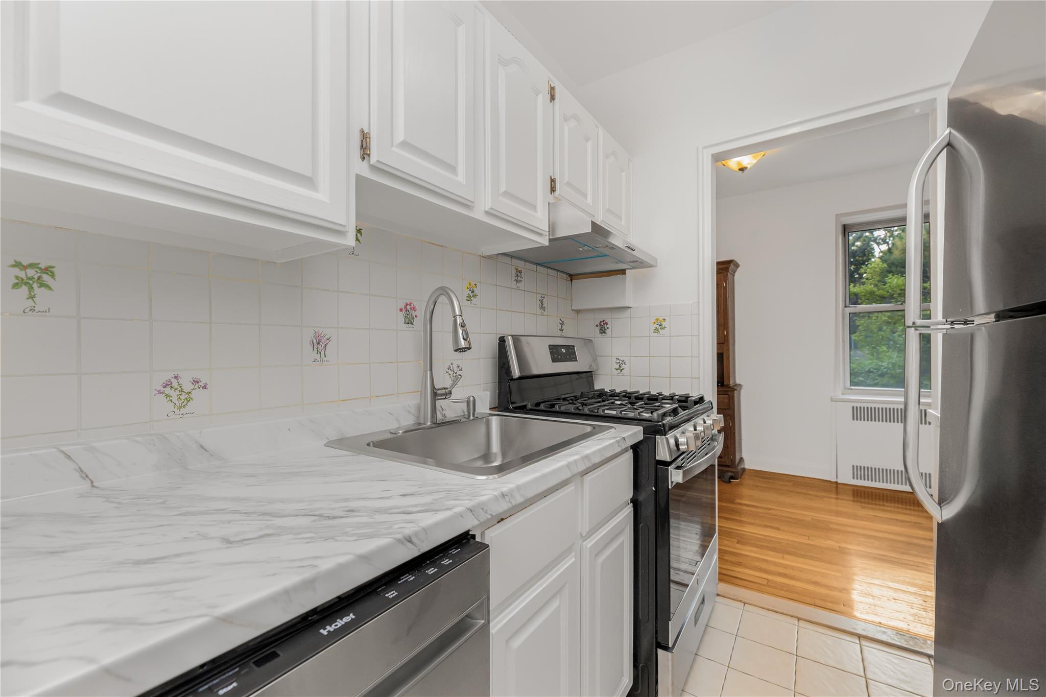 766 Palmer Road, Unit 2D Bronxville, NY 10708 - Photo 5 of 21 a kitchen with granite countertop a sink a stove and refrigerator