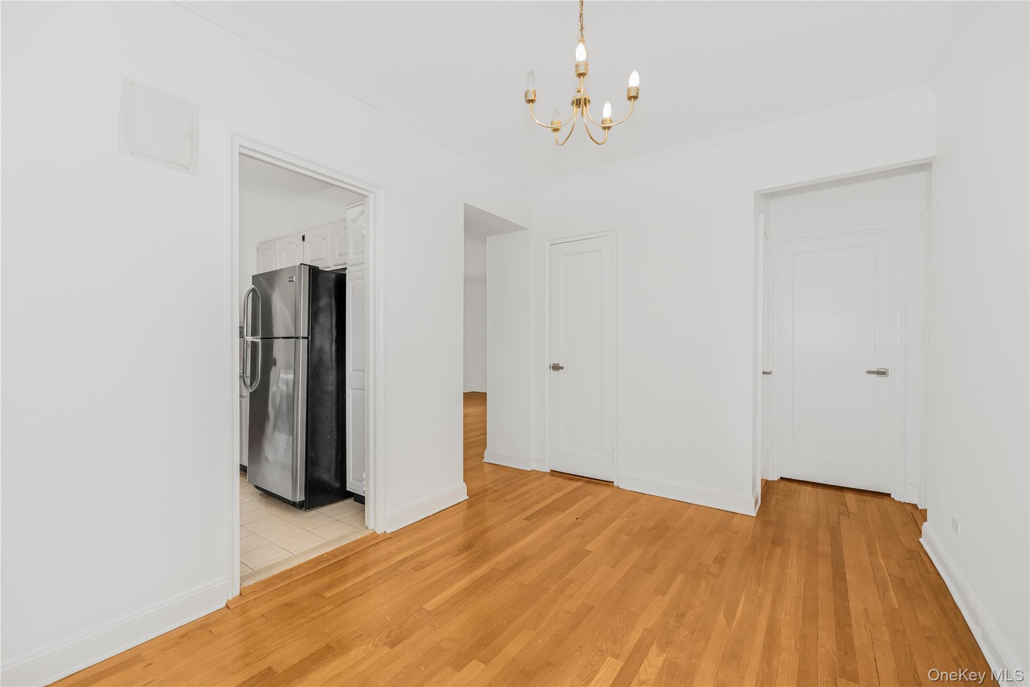 766 Palmer Road, Unit 2D Bronxville, NY 10708 - Photo 8 of 21 a view of a room with wooden floor and chandelier