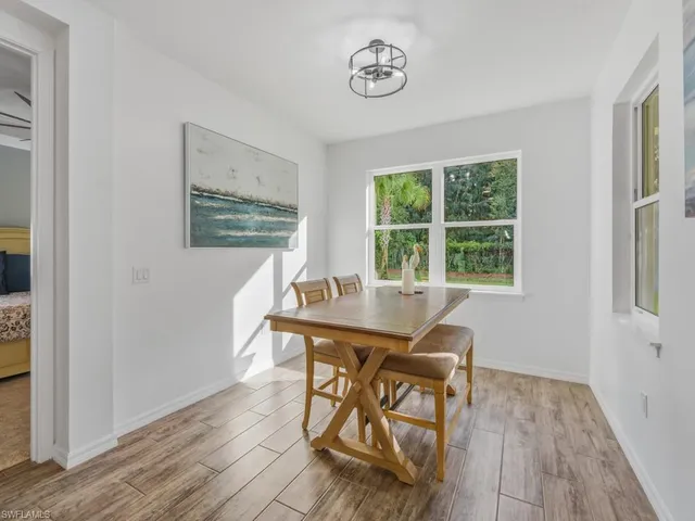 a view of a workspace room with wooden floor and windows