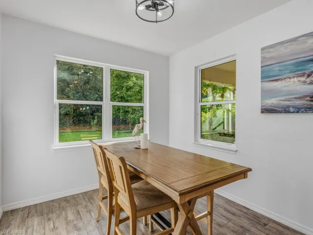 a view of a dining room with furniture and a window