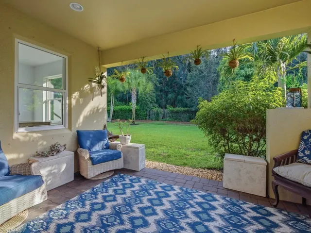 a view of a patio with chairs and plants