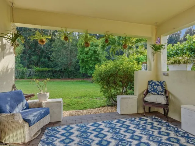 a view of a patio with couches chairs and a yard